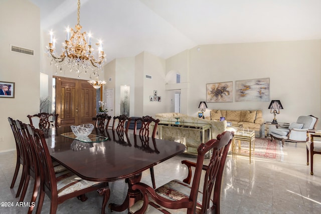 dining area featuring high vaulted ceiling, tile patterned flooring, and an inviting chandelier