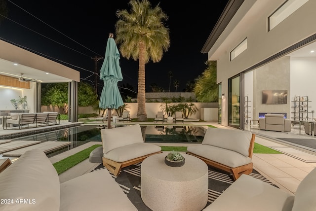 patio at twilight featuring outdoor lounge area