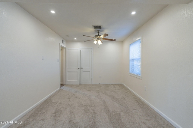 carpeted empty room featuring ceiling fan, baseboards, visible vents, and recessed lighting