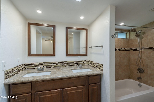 bathroom with ceiling fan, vanity, and tiled shower / bath combo