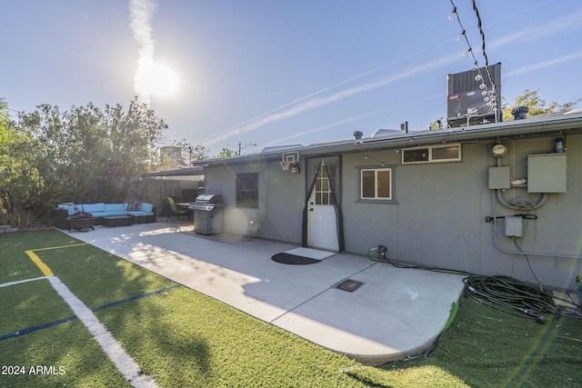 rear view of house with a patio area, a yard, outdoor lounge area, fence, and cooling unit