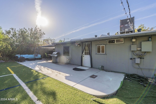 rear view of property with area for grilling, cooling unit, a patio, an outdoor hangout area, and a lawn