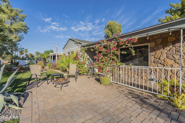view of patio / terrace featuring an outdoor fire pit