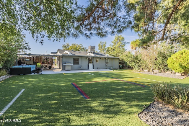 rear view of house with a pergola, a patio, a yard, and an outdoor hangout area