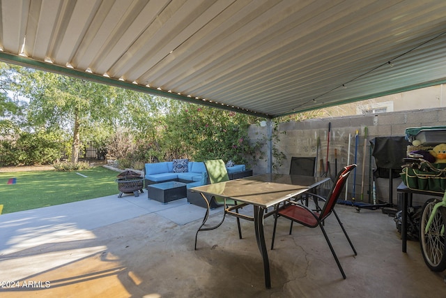 view of patio with an outdoor living space with a fire pit, a fenced backyard, and outdoor dining area