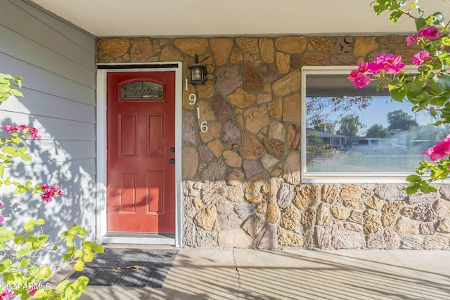 view of exterior entry featuring stone siding