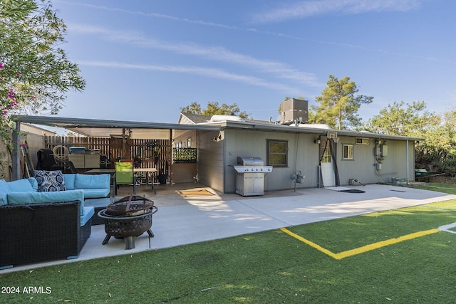 back of house with an outdoor fire pit, a patio, and a lawn