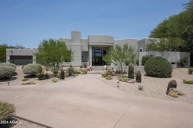 pueblo revival-style home with a garage