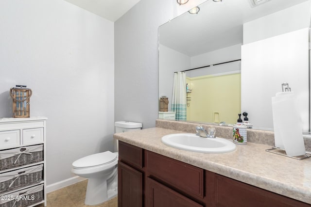 bathroom featuring vanity, toilet, curtained shower, and tile patterned flooring