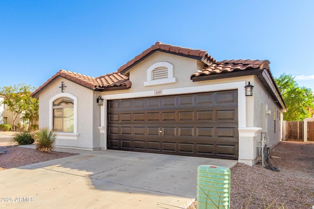 mediterranean / spanish-style house with a garage