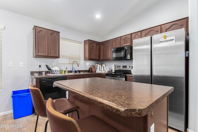 kitchen featuring black appliances, a center island, sink, a kitchen breakfast bar, and light tile patterned floors