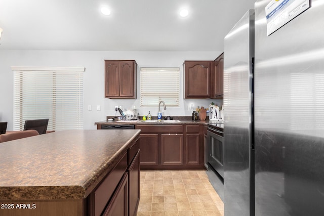 kitchen featuring sink, a kitchen island, and appliances with stainless steel finishes