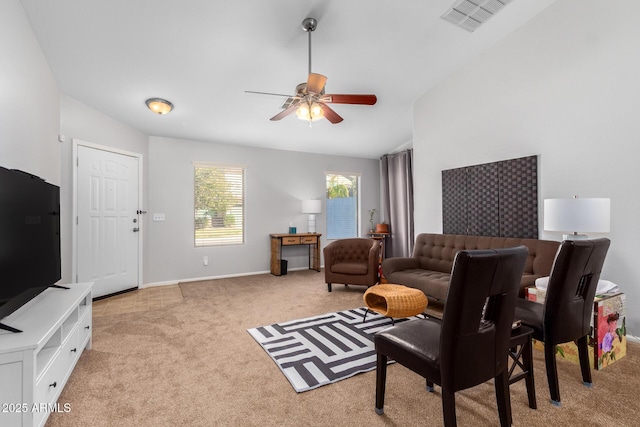 living room featuring light colored carpet, vaulted ceiling, and ceiling fan