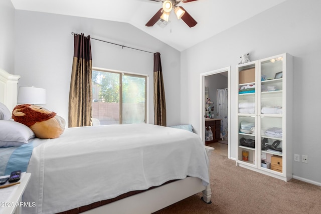 carpeted bedroom with ceiling fan, connected bathroom, and vaulted ceiling