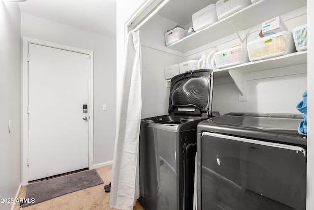 washroom featuring washing machine and clothes dryer and carpet