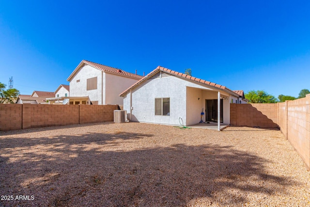 rear view of property with central AC unit