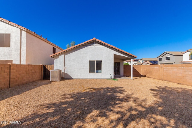 back of house with central air condition unit and a patio area