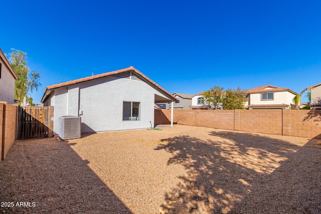 back of house featuring central AC unit