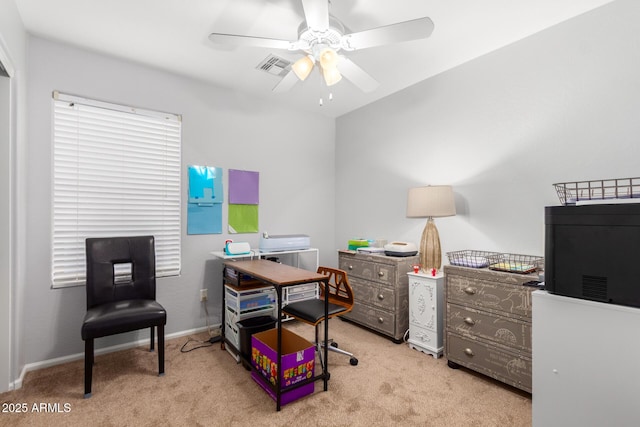 carpeted office space featuring ceiling fan