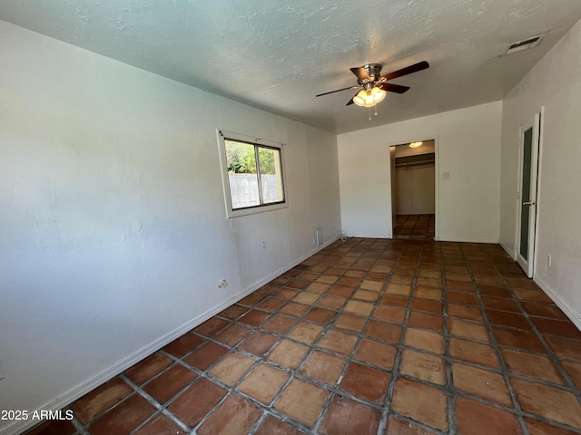 1618 W Vernon Ave, Phoenix, AZ 85007 - unfurnished bedroom with baseboards, a textured ceiling, a spacious closet, ceiling fan, and a closet