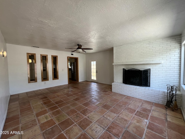 1618 W Vernon Ave, Phoenix, AZ 85007 - unfurnished living room with a brick fireplace, a textured ceiling, a ceiling fan, tile patterned flooring, and baseboards