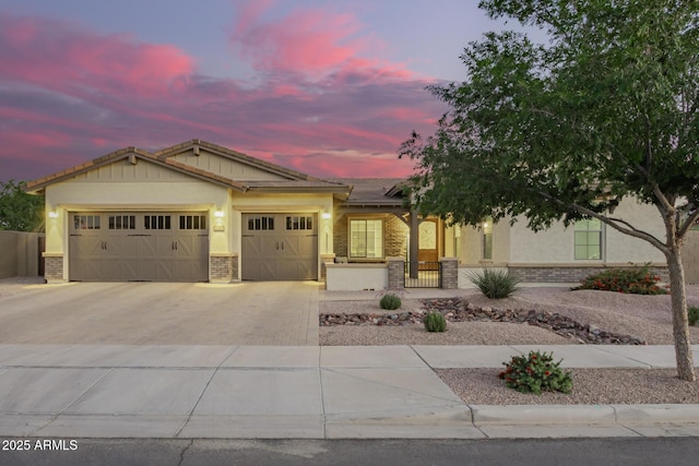 ranch-style home with stucco siding, solar panels, brick siding, an attached garage, and driveway