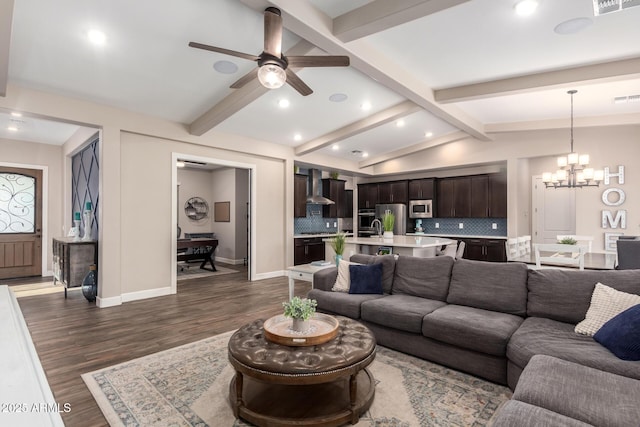 living area featuring baseboards, lofted ceiling with beams, recessed lighting, ceiling fan with notable chandelier, and dark wood-type flooring
