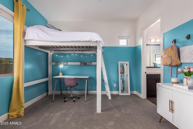 bedroom featuring carpet floors, baseboards, and connected bathroom
