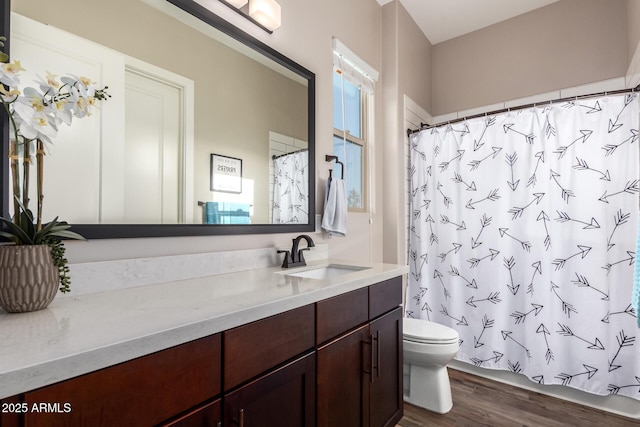 full bath with toilet, curtained shower, vanity, and wood finished floors