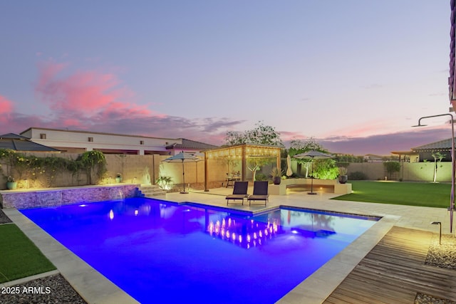 pool at dusk featuring a gazebo, a patio, a fenced backyard, and a lawn