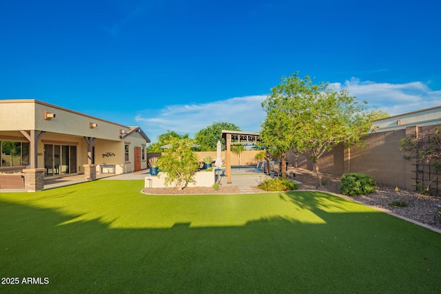 view of yard featuring a patio area and a fenced backyard