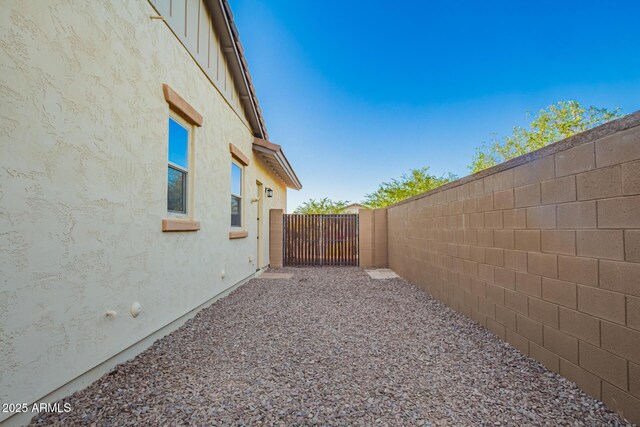 view of property exterior featuring a fenced backyard and stucco siding