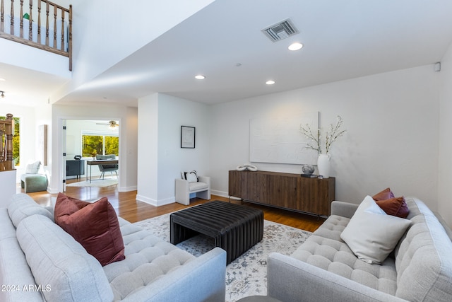 living room featuring wood-type flooring and ceiling fan