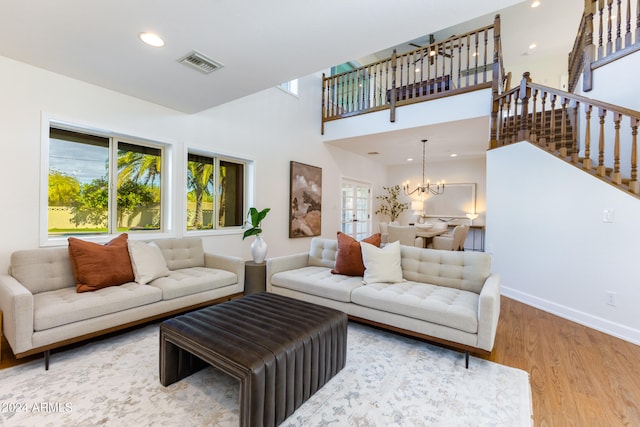 living room featuring wood-type flooring and a notable chandelier