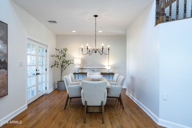 dining room featuring hardwood / wood-style floors and an inviting chandelier