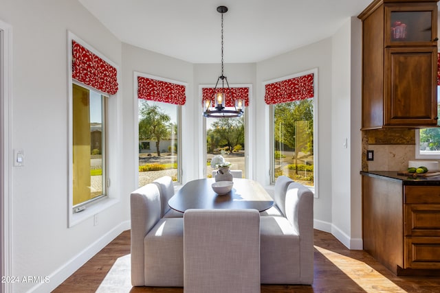 dining room featuring a chandelier and dark hardwood / wood-style floors