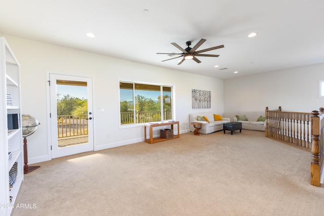 sitting room featuring light carpet and ceiling fan