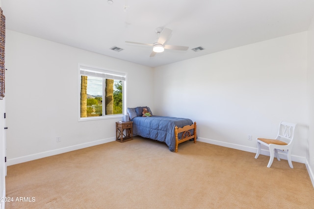 bedroom featuring ceiling fan and light carpet