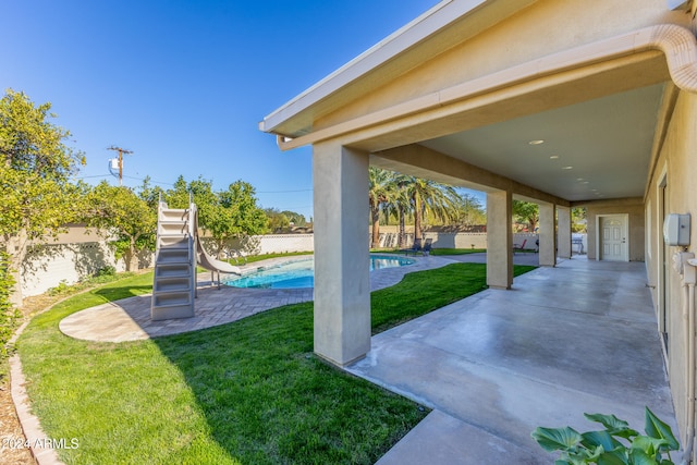 exterior space featuring a patio and a fenced in pool