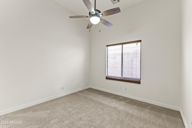 empty room featuring light carpet and ceiling fan