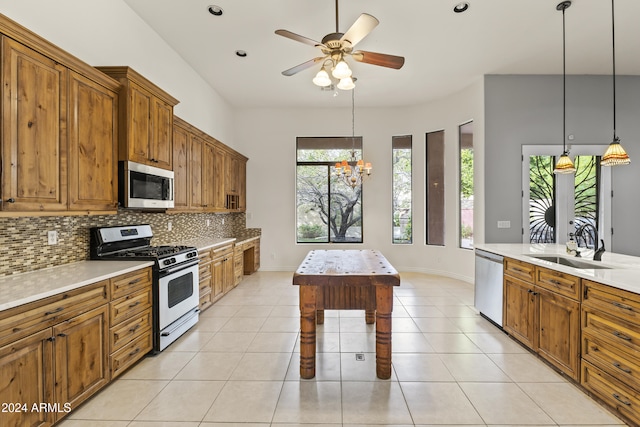 kitchen with light tile patterned floors, stainless steel appliances, and a wealth of natural light