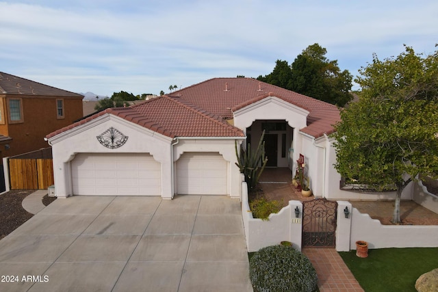 mediterranean / spanish home with a garage