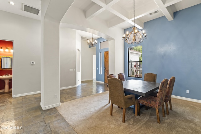 dining area with beamed ceiling, sink, and coffered ceiling