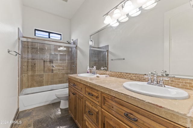 full bathroom with tasteful backsplash, vanity, enclosed tub / shower combo, and toilet