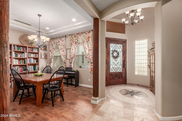 dining room featuring a notable chandelier and a tray ceiling