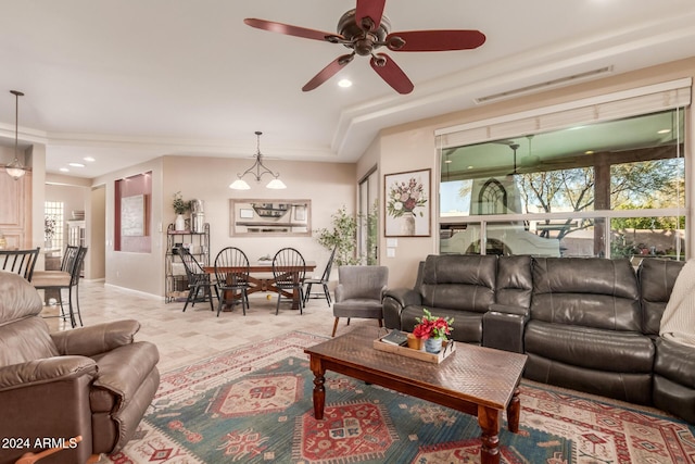 living room featuring ceiling fan and a tray ceiling