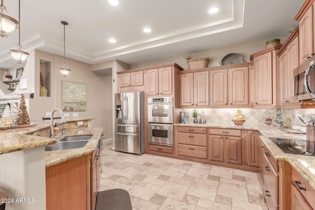 kitchen featuring light stone counters, pendant lighting, stainless steel appliances, and sink