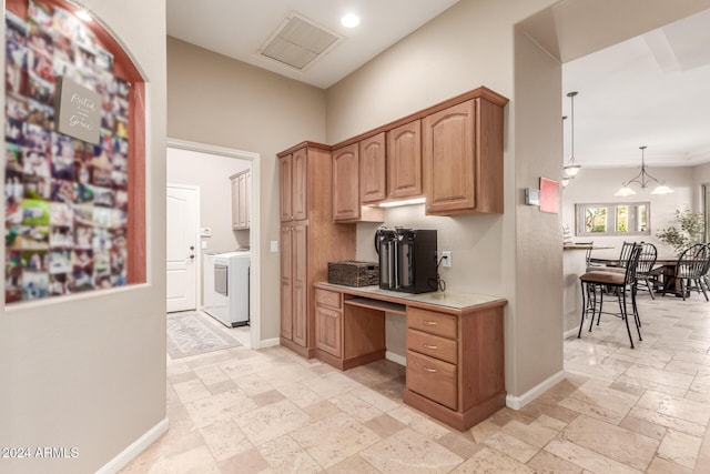 kitchen featuring decorative light fixtures and washer / clothes dryer