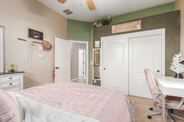 carpeted bedroom with ceiling fan and a closet