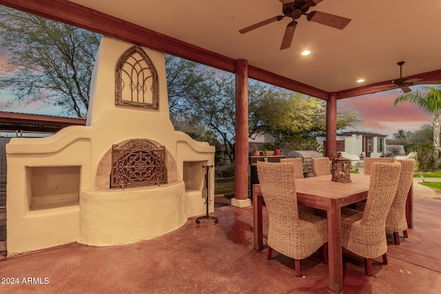 patio terrace at dusk featuring ceiling fan